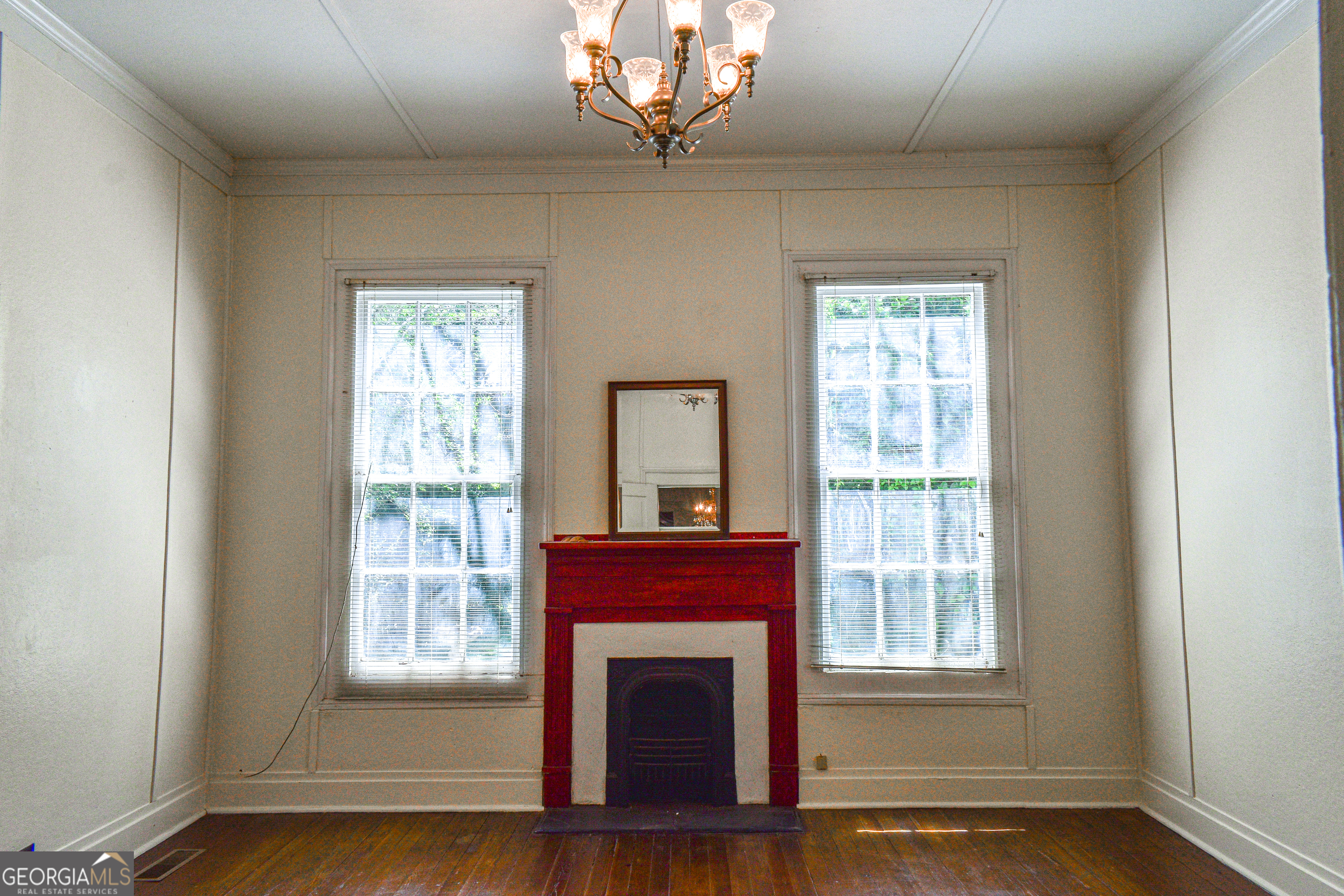100 Minor Avenue Montezuma, GA 31063 - Photo 15 of 43 a view of an empty room with wooden floor and a window