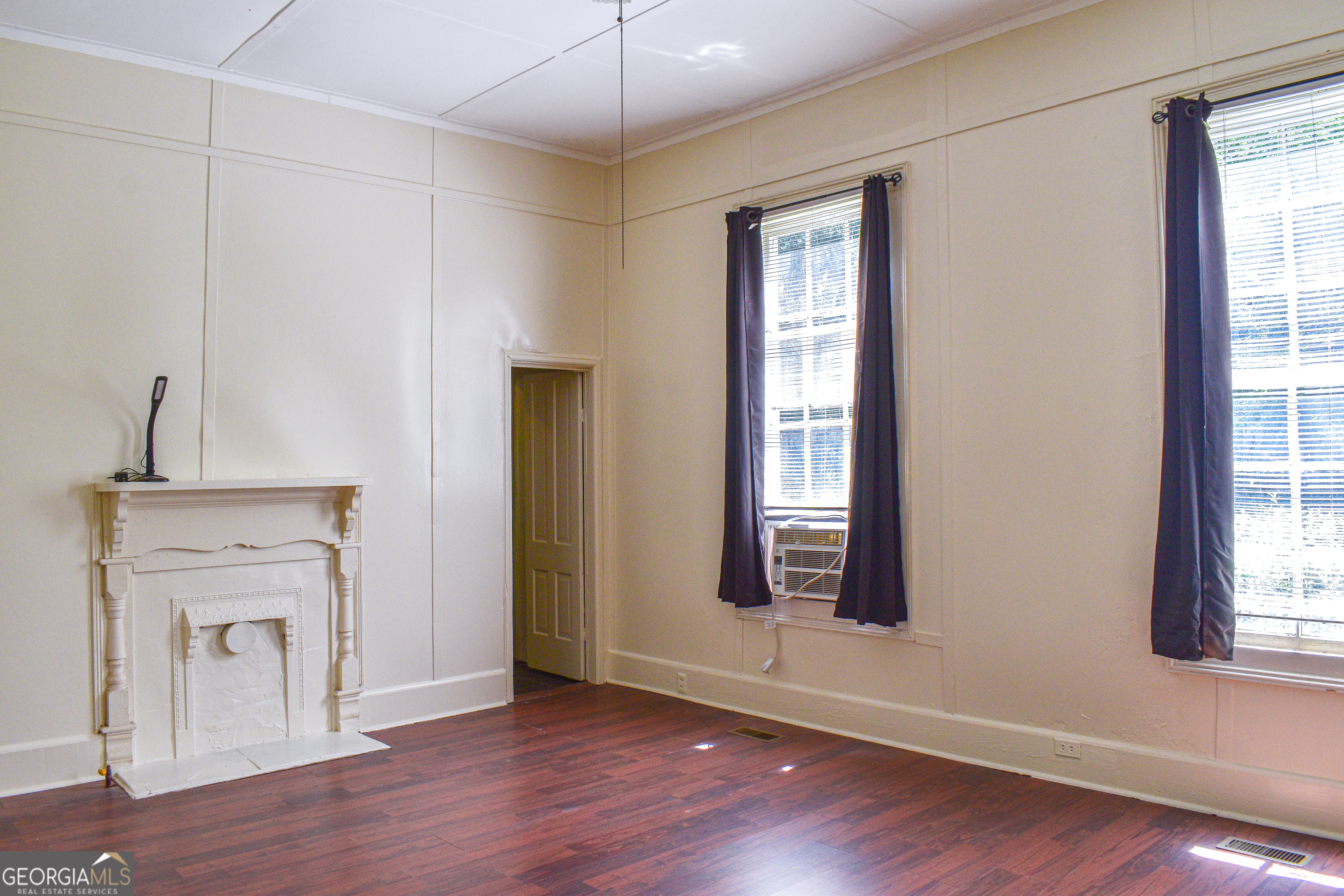 100 Minor Avenue Montezuma, GA 31063 - Photo 18 of 43 an empty room with wooden floor fan and windows