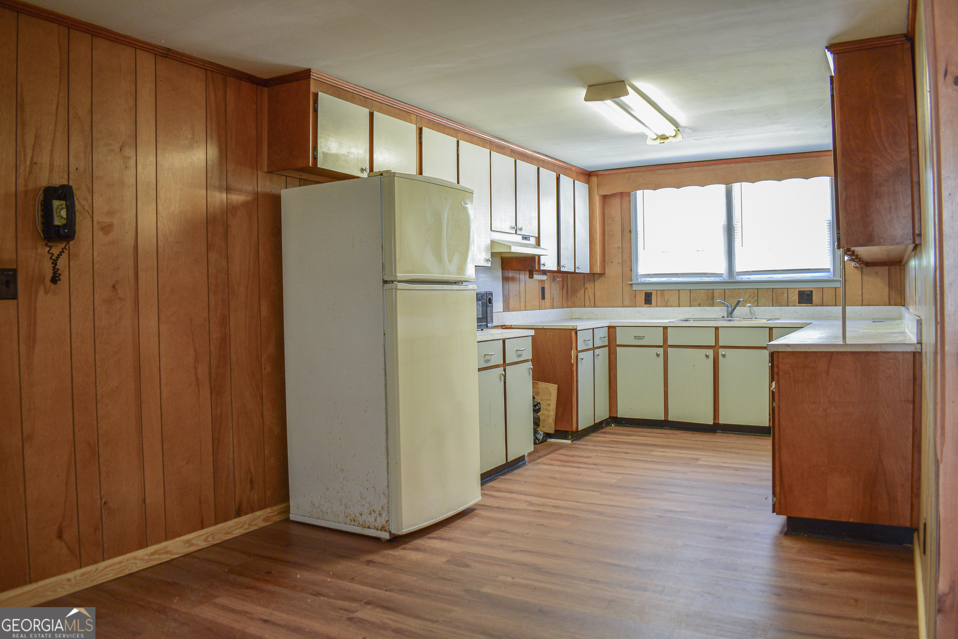 100 Minor Avenue Montezuma, GA 31063 - Photo 30 of 43 a kitchen with kitchen island wooden cabinets a sink appliances and cabinets