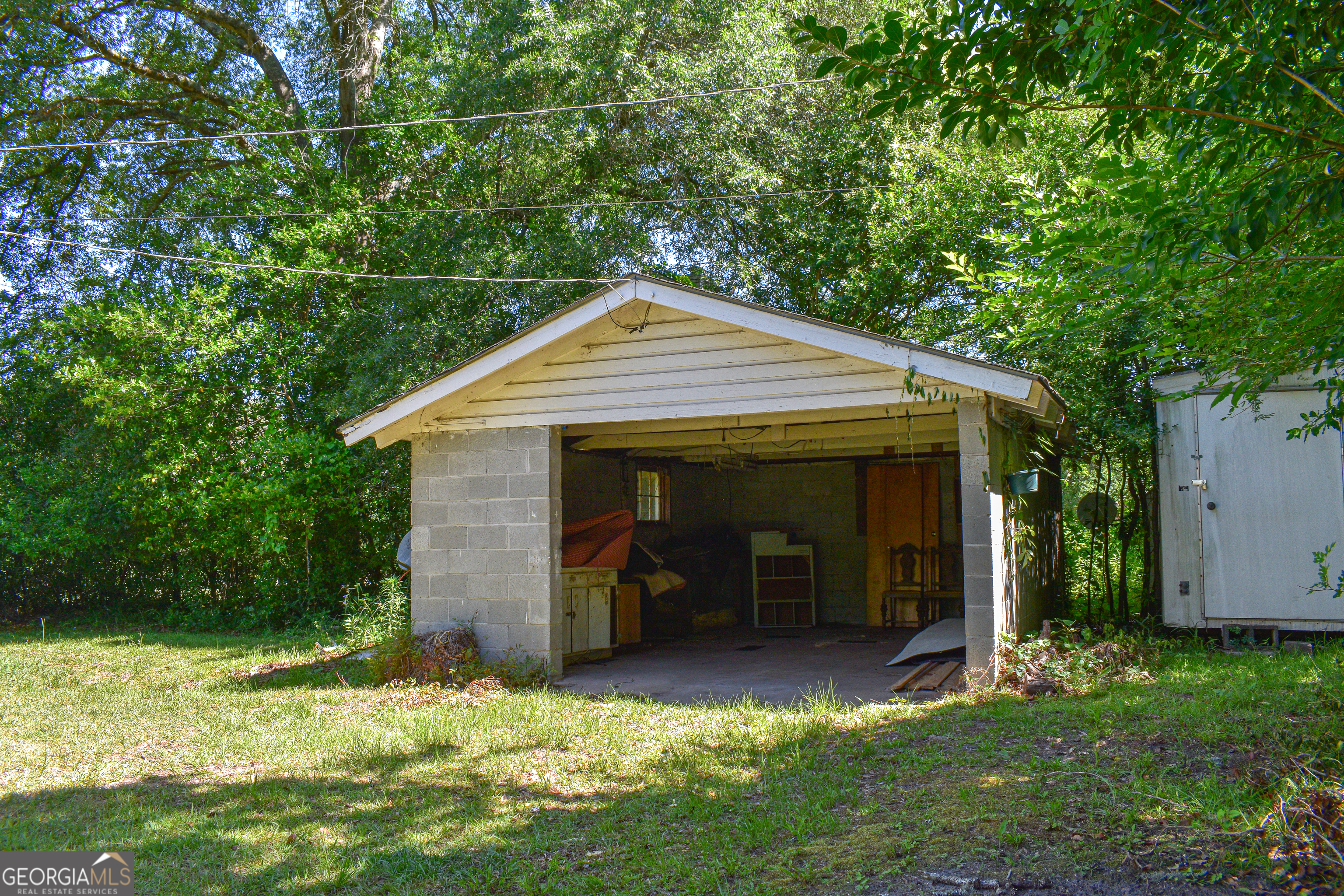 100 Minor Avenue Montezuma, GA 31063 - Photo 6 of 43 a backyard of a house with yard and outdoor seating