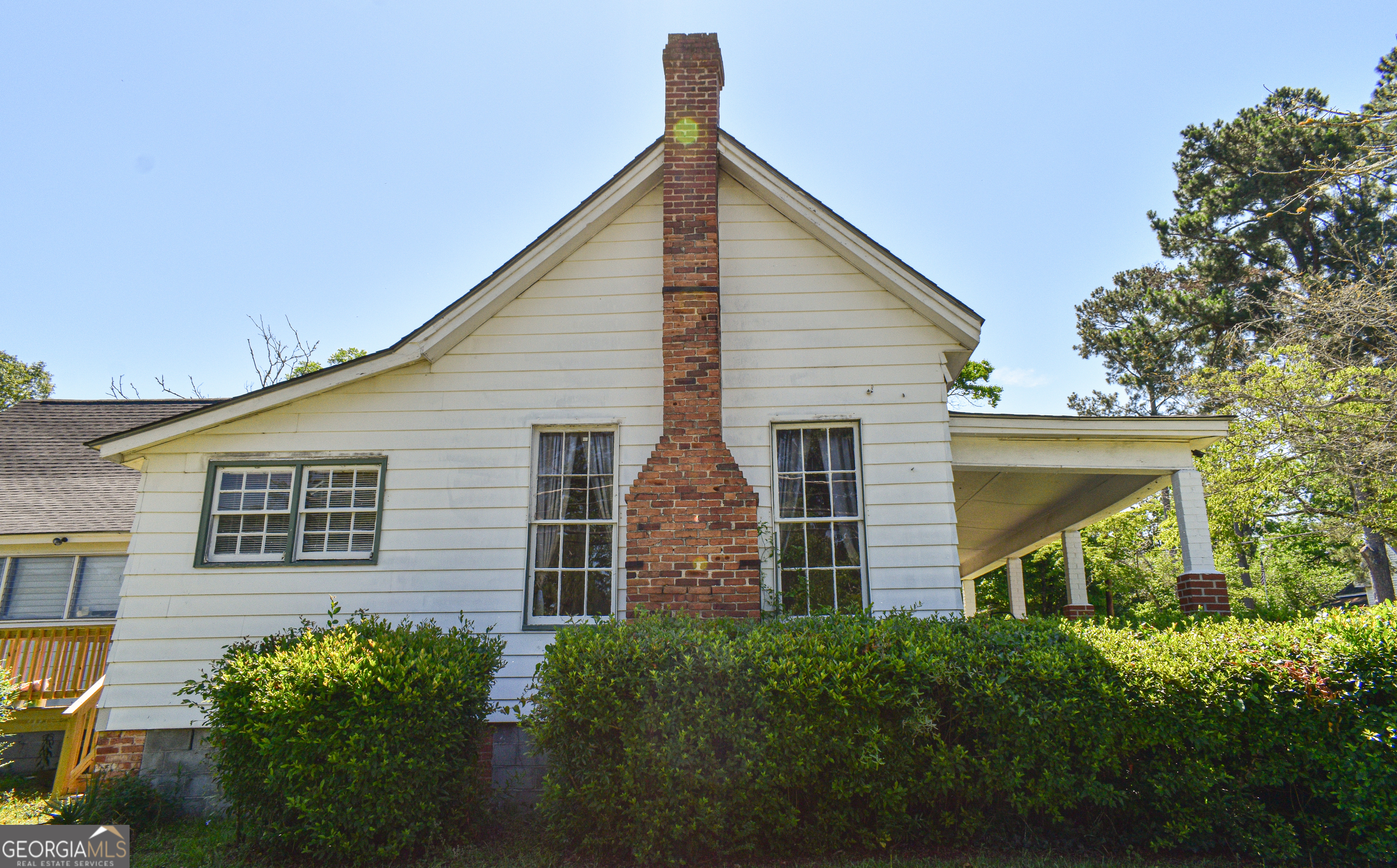 100 Minor Avenue Montezuma, GA 31063 - Photo 10 of 43 a view of a house with large windows and a yard