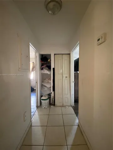 a bedroom with a bed and a dresser next to a window