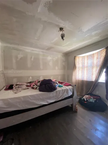 a bedroom with bed and a lamp