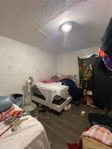 a bathroom with a toilet a sink a mirror and shower