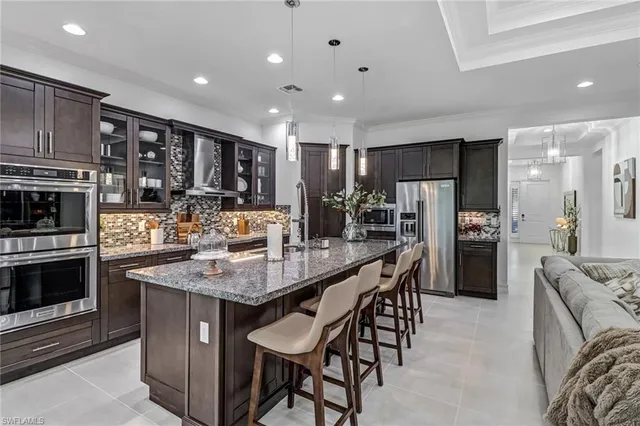 a view of a patio with couches table and chairs and potted plants