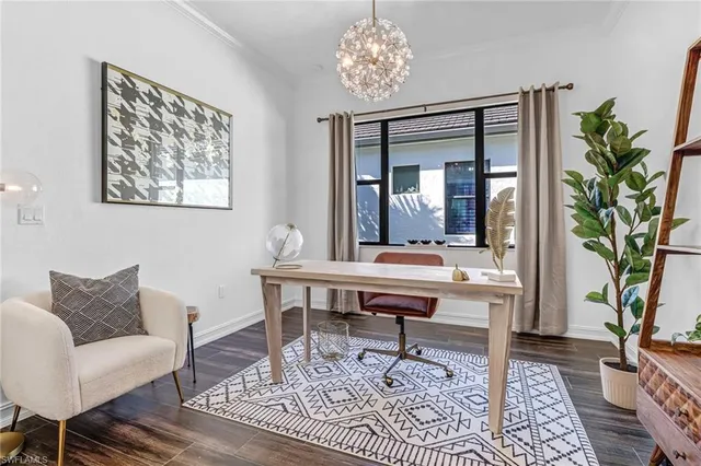 a work room with furniture and a potted plant