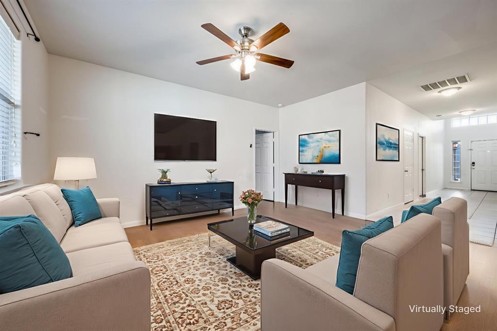 2813 Joshua Street Denton, TX 76209 - Photo 3 of 17 a living room with furniture and a flat screen tv