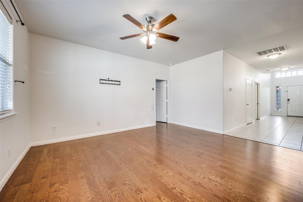 2813 Joshua Street Denton, TX 76209 - Photo 4 of 17 an empty room with wooden floor and ceiling fan