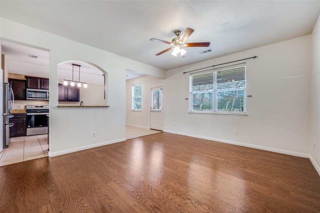 2813 Joshua Street Denton, TX 76209 - Photo 6 of 17 a view of an empty room with window and wooden floor