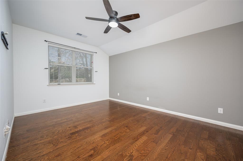 2813 Joshua Street Denton, TX 76209 - Photo 8 of 17 an empty room with wooden floor ceiling fan and windows
