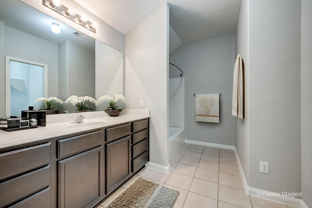 2813 Joshua Street Denton, TX 76209 - Photo 9 of 17 a bathroom with a sink and mirror