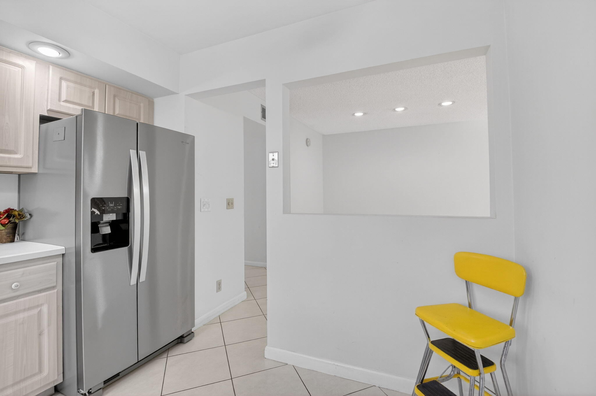 136 Capri B Delray Beach, FL 33484 - Photo 11 of 42 a kitchen that has a refrigerator and a chair in it