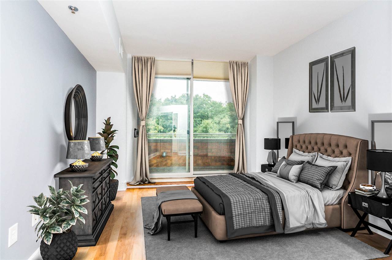 a bedroom with a bed and a chandelier