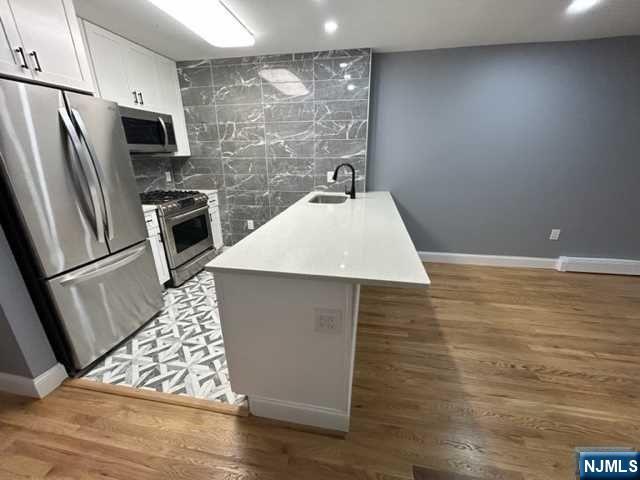 a kitchen with stainless steel appliances a refrigerator sink and stove