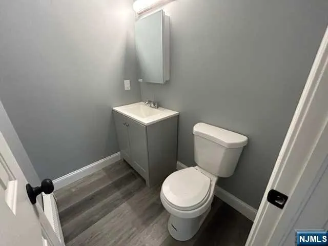 a white toilet sitting next to a bathroom sink