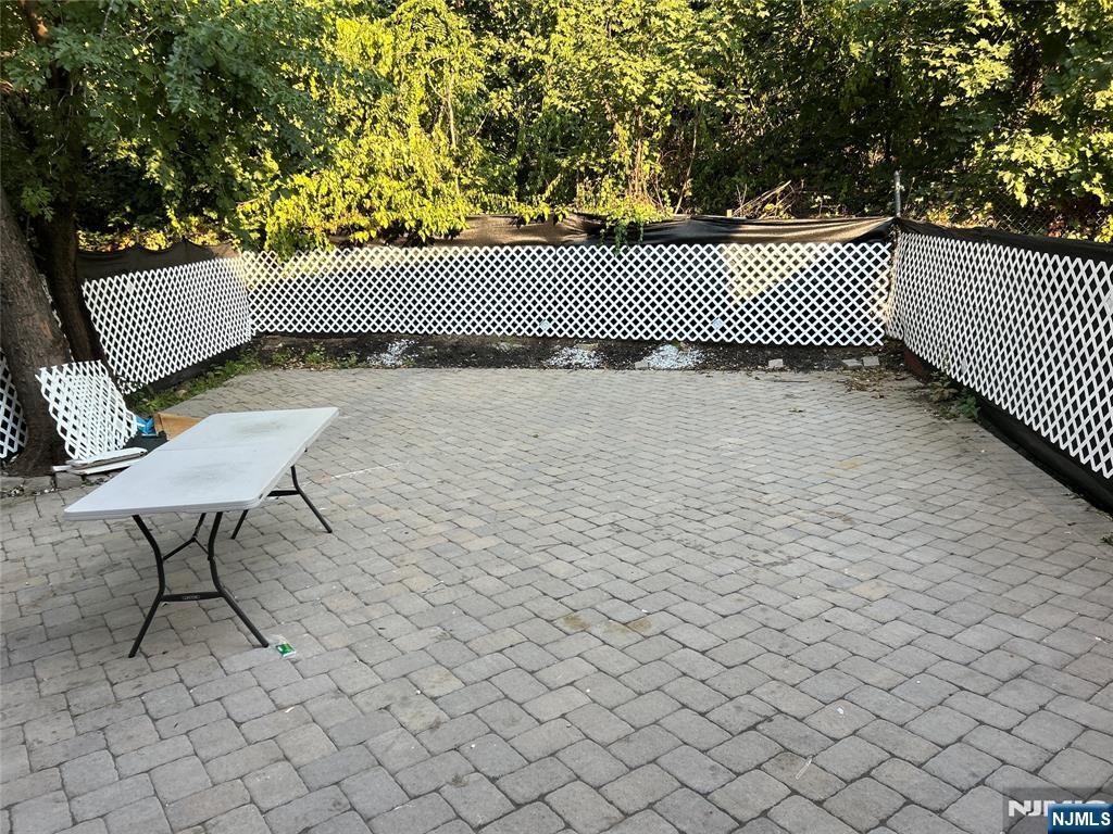 47 Ann Street, Unit 1 Paterson, NJ 07501 - Photo 19 of 20 a view of a roof deck with wooden fence and bench