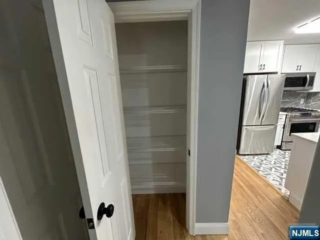 a kitchen with a refrigerator and microwave