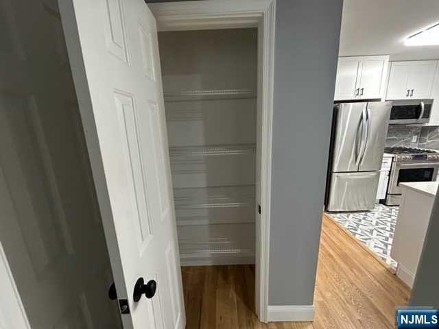 47 Ann Street, Unit 1 Paterson, NJ 07501 - Photo 6 of 20 a kitchen with a refrigerator and microwave