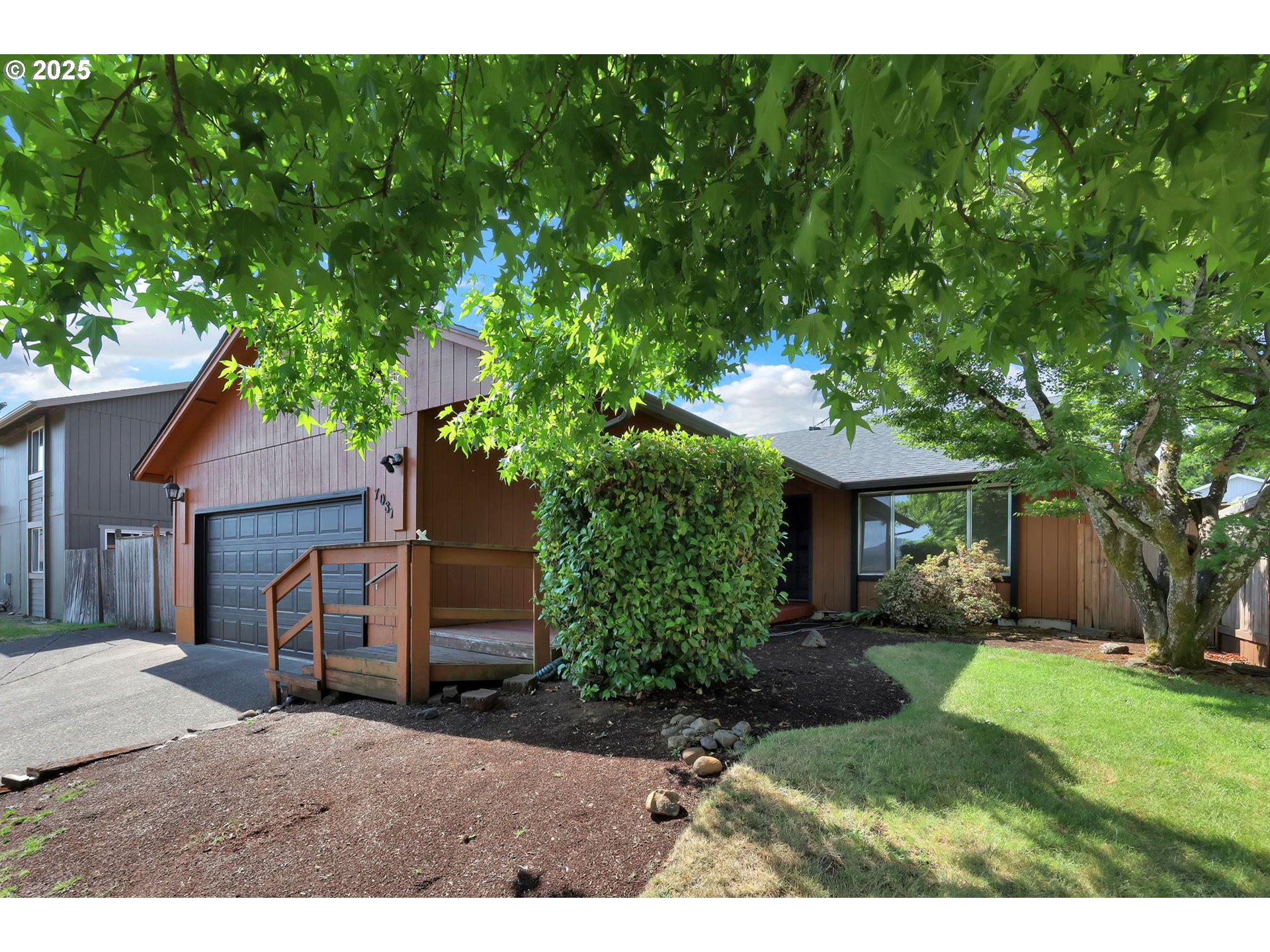 7087 Aster Street Springfield, OR 97478 - Photo 1 of 46 a view of a yard in front of a house with large tree