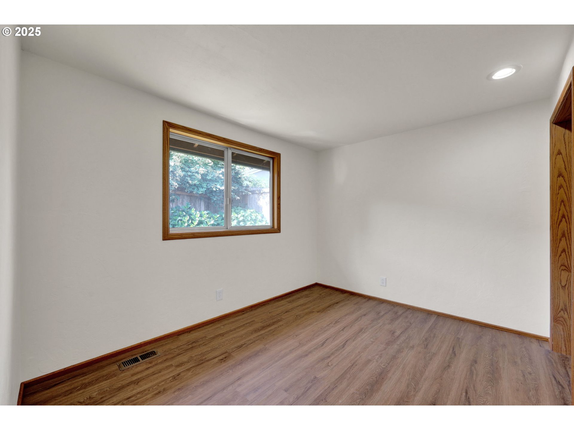 7087 Aster Street Springfield, OR 97478 - Photo 22 of 46 a view of an empty room with wooden floor