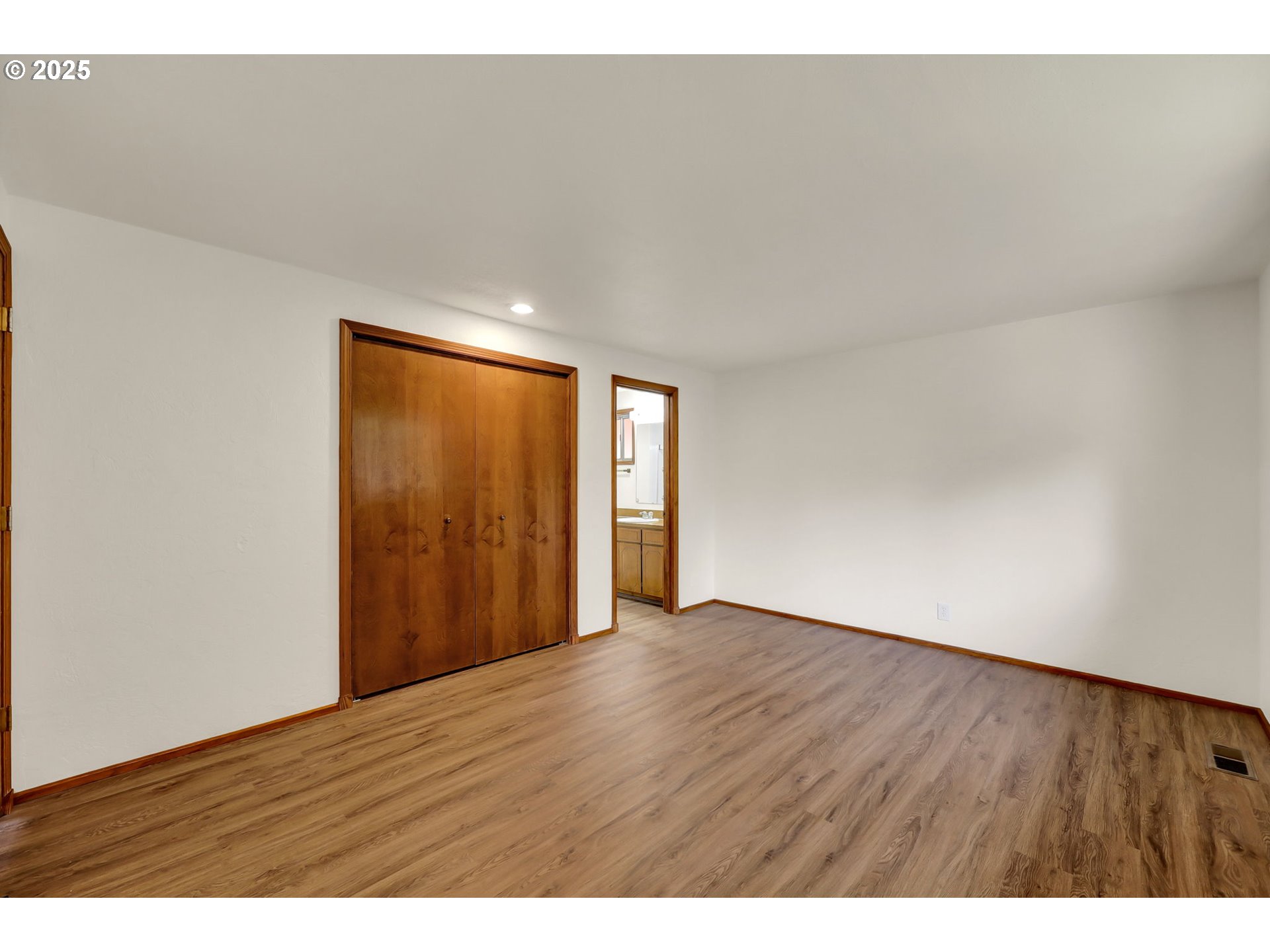 7087 Aster Street Springfield, OR 97478 - Photo 26 of 46 a view of an empty room with wooden floor and a window