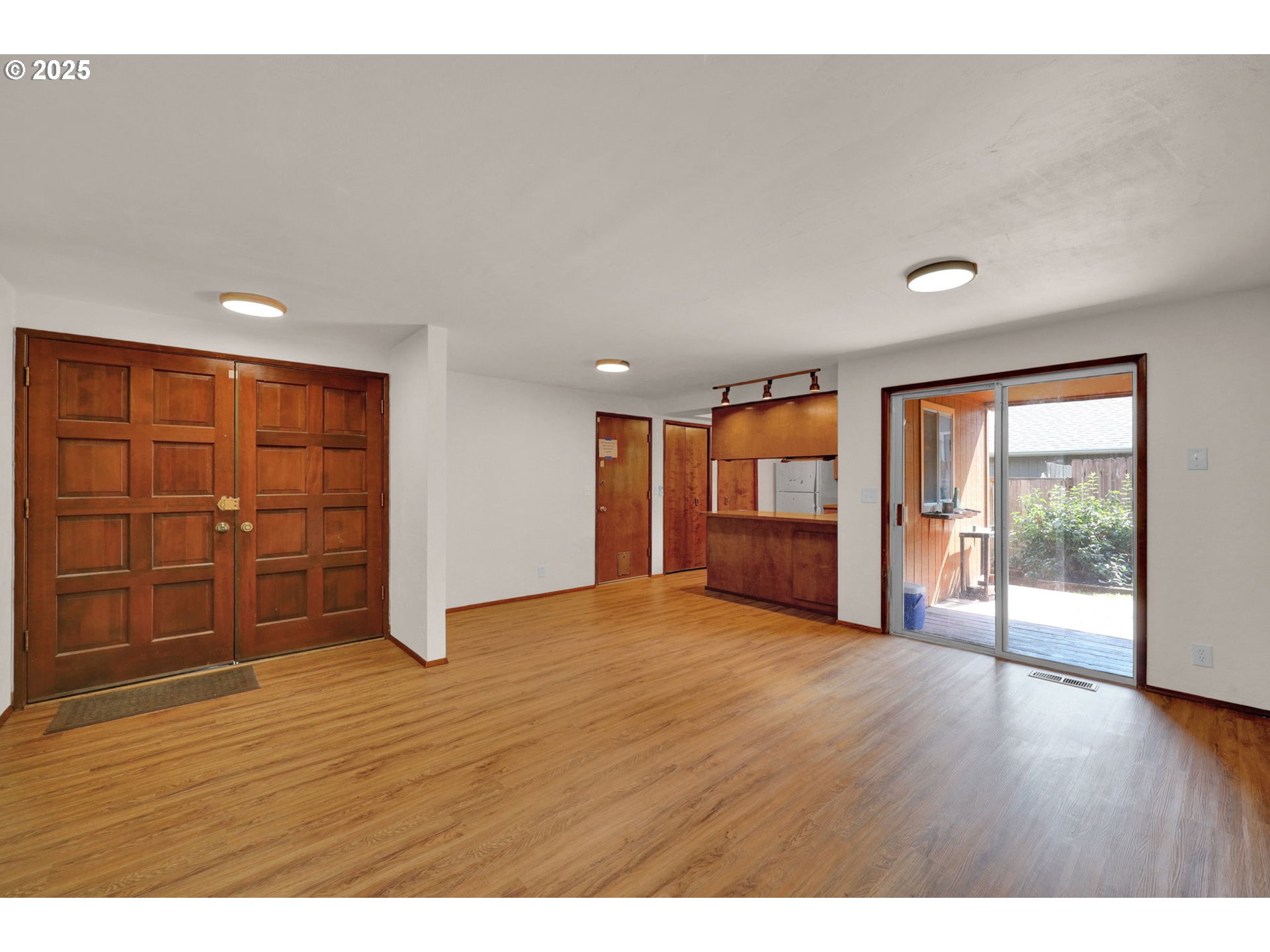 7087 Aster Street Springfield, OR 97478 - Photo 3 of 46 a view of an empty room with wooden floor and a window