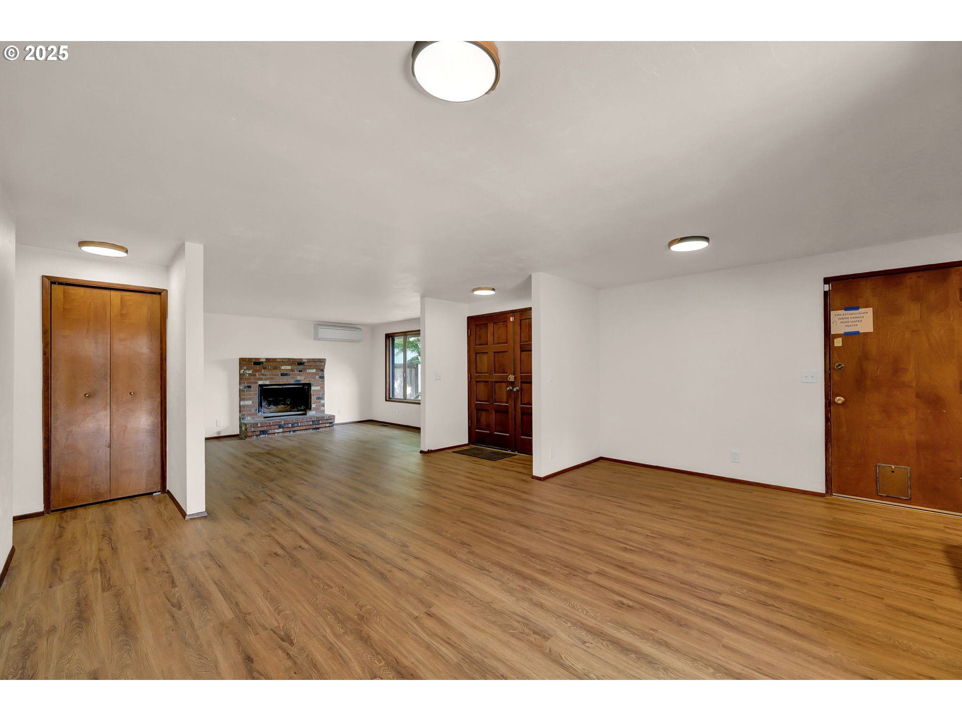 7087 Aster Street Springfield, OR 97478 - Photo 4 of 46 a view of empty room with wooden floor and fireplace