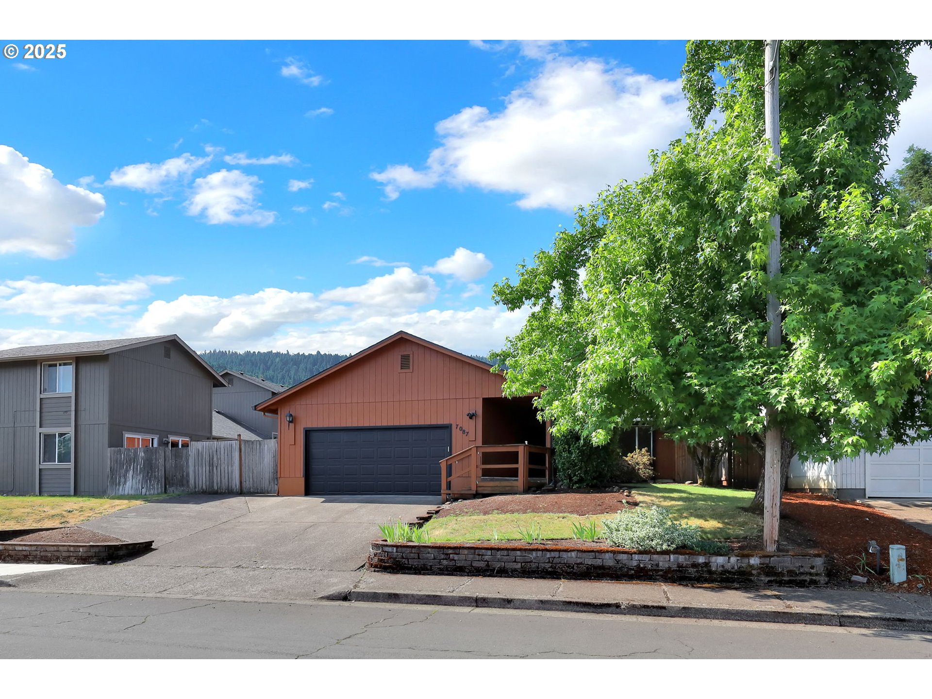 7087 Aster Street Springfield, OR 97478 - Photo 42 of 46 a house with trees in the background