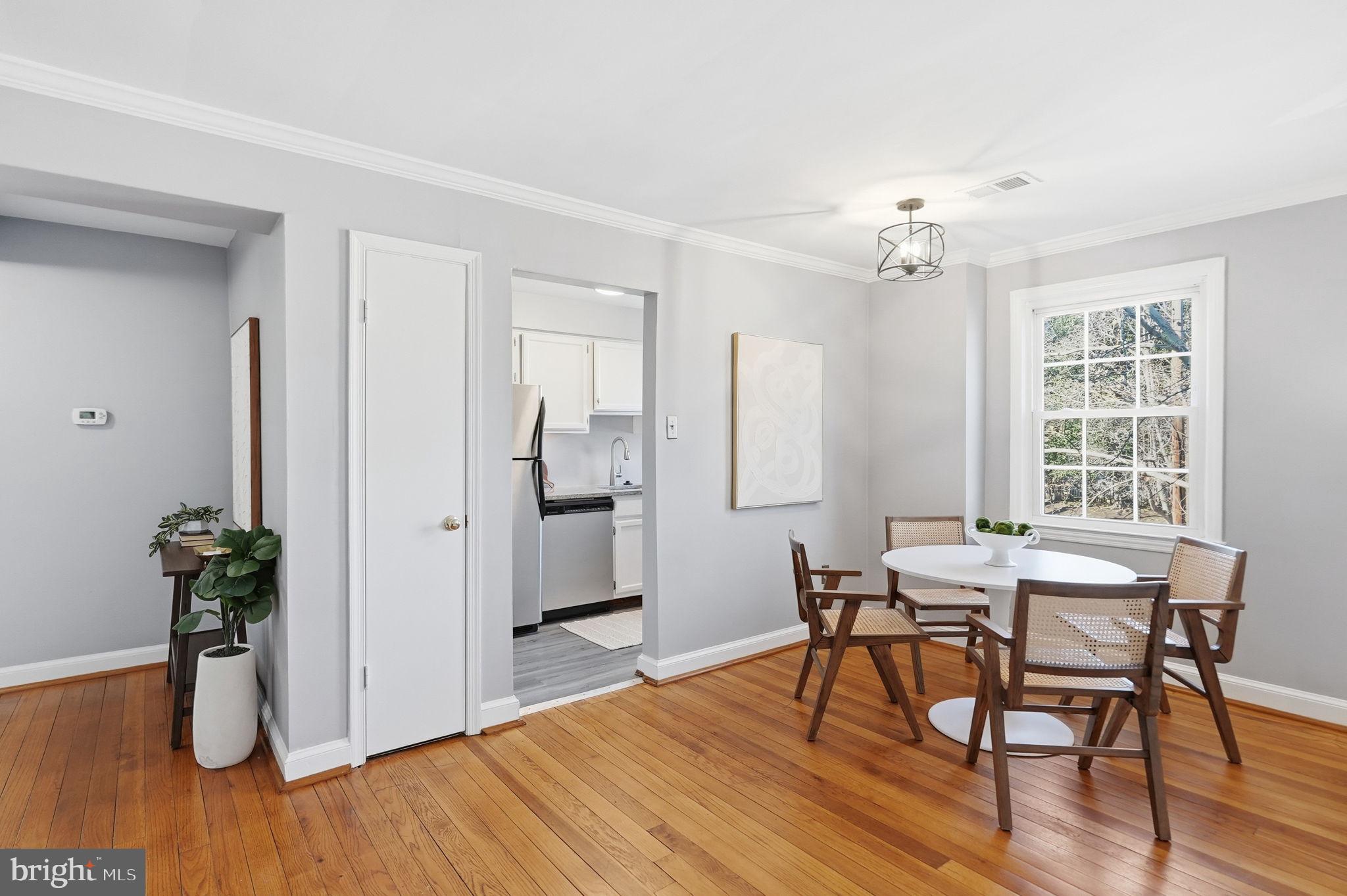 2900 13th Road South, Unit 201 Arlington, VA 22204 - Photo 11 of 32 a view of a dining room with furniture and wooden floor