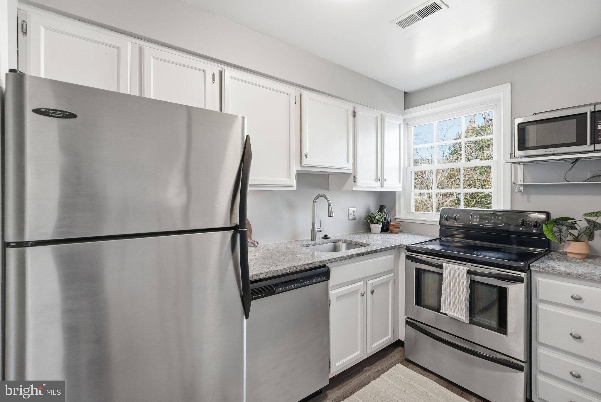 2900 13th Road South, Unit 201 Arlington, VA 22204 - Photo 14 of 32 a white refrigerator freezer sitting in a kitchen