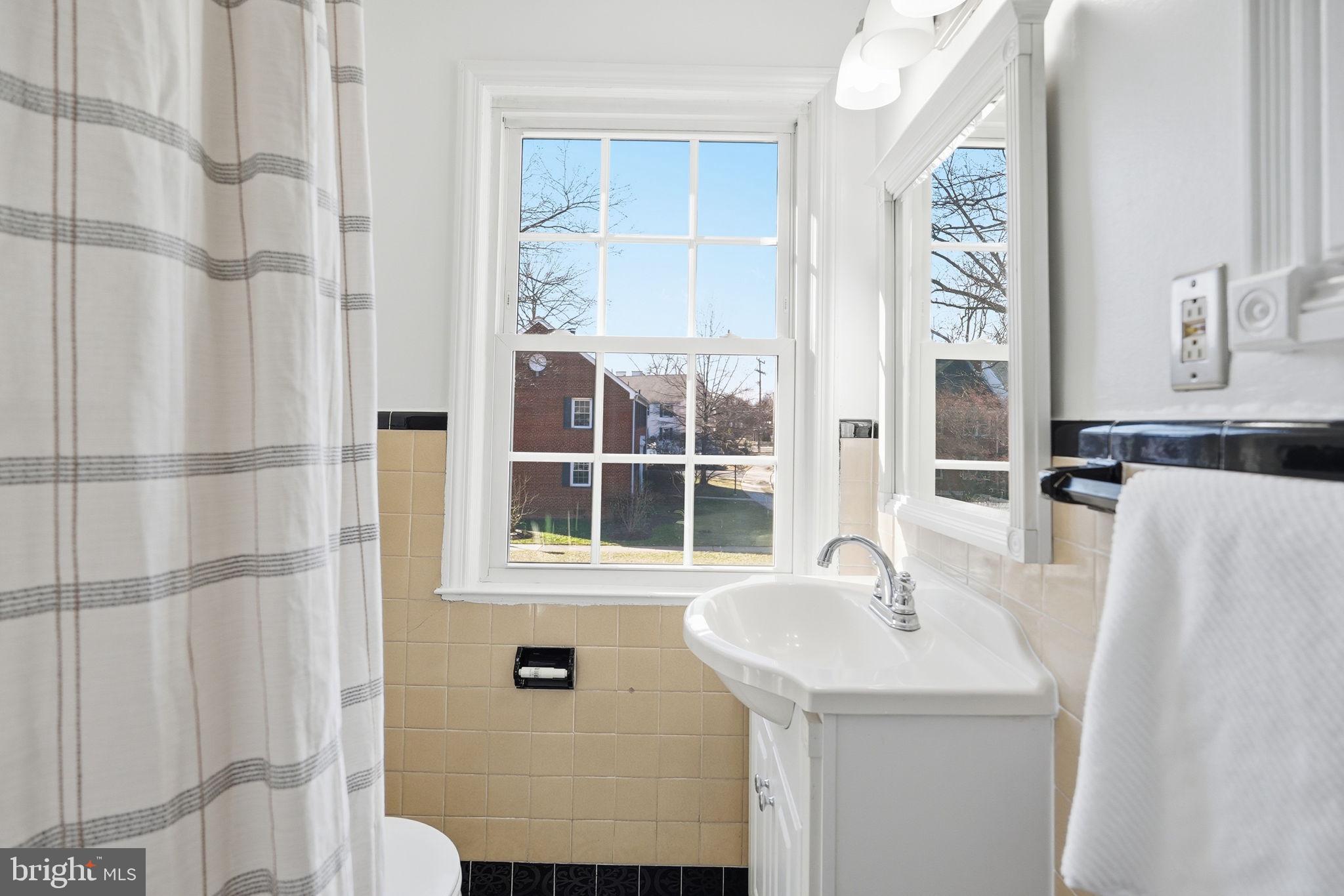 2900 13th Road South, Unit 201 Arlington, VA 22204 - Photo 23 of 32 a bathroom with a sink and a mirror