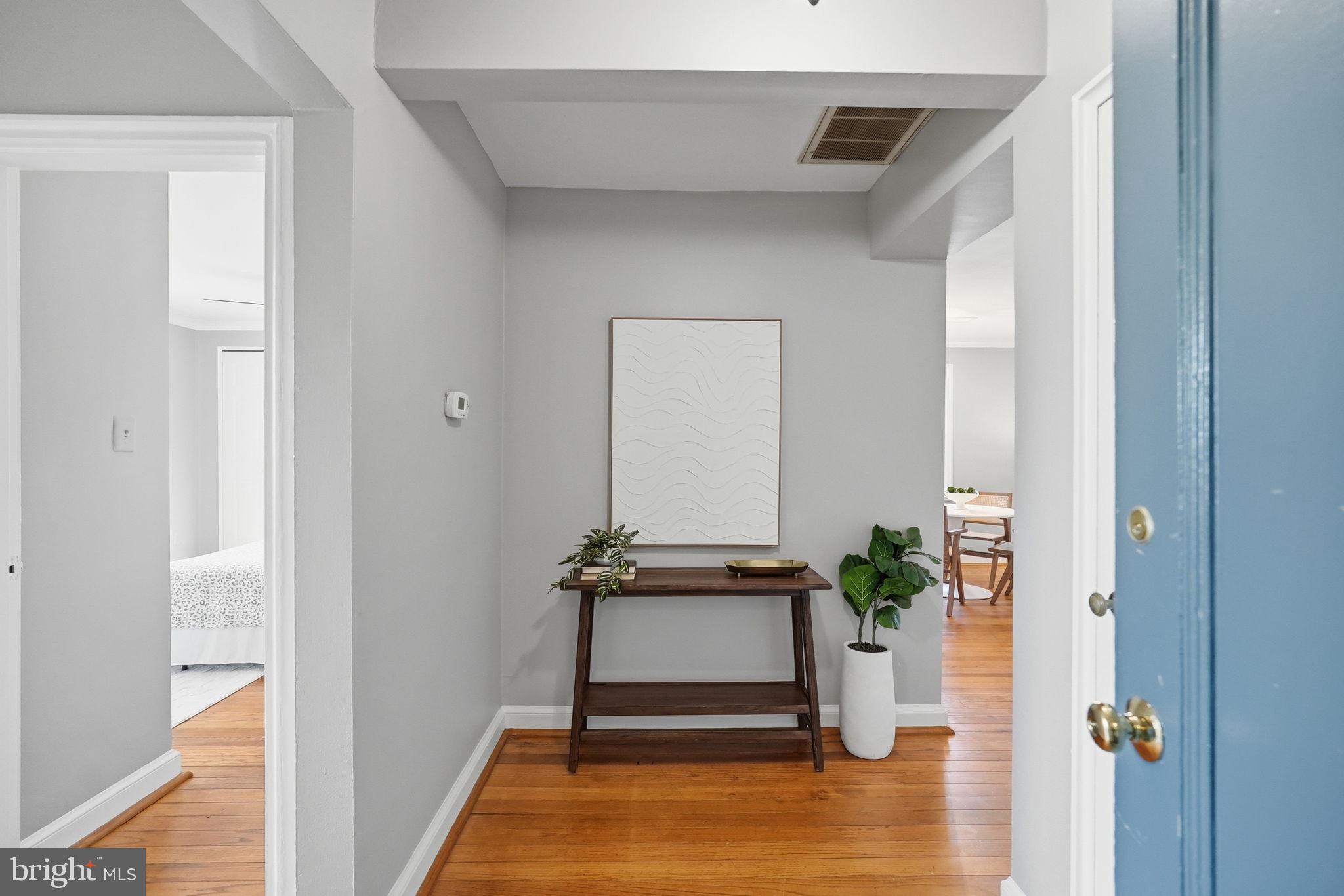 2900 13th Road South, Unit 201 Arlington, VA 22204 - Photo 3 of 32 a view of a hallway with wooden floor and a potted plant