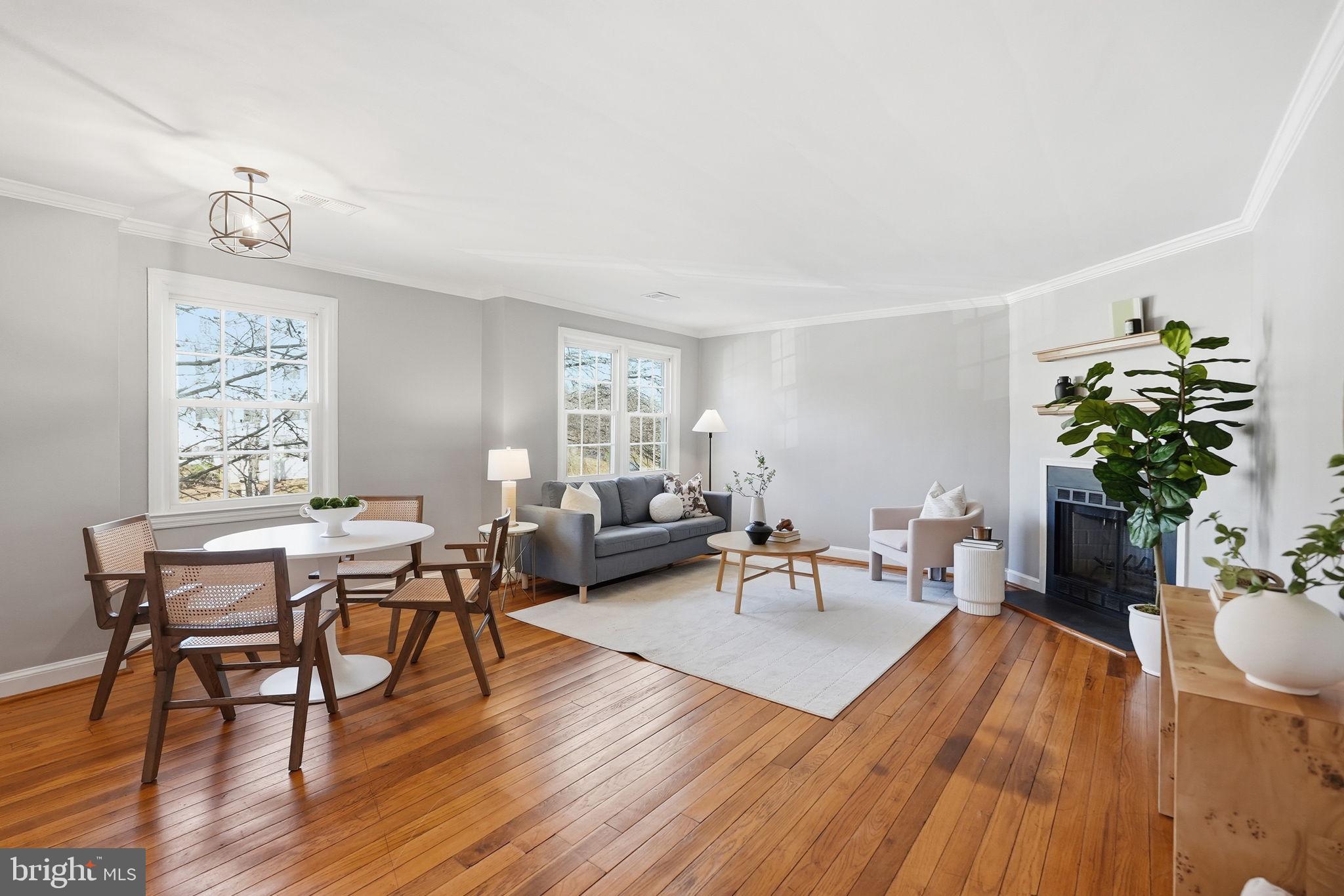 2900 13th Road South, Unit 201 Arlington, VA 22204 - Photo 4 of 32 a living room with furniture a dining table with wooden floor and potted plants
