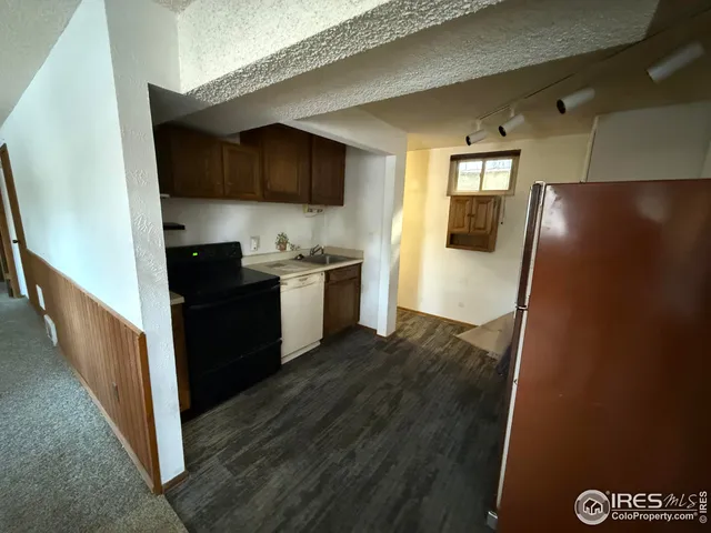 a kitchen that has a sink stainless steel appliances a counter space and a refrigerator