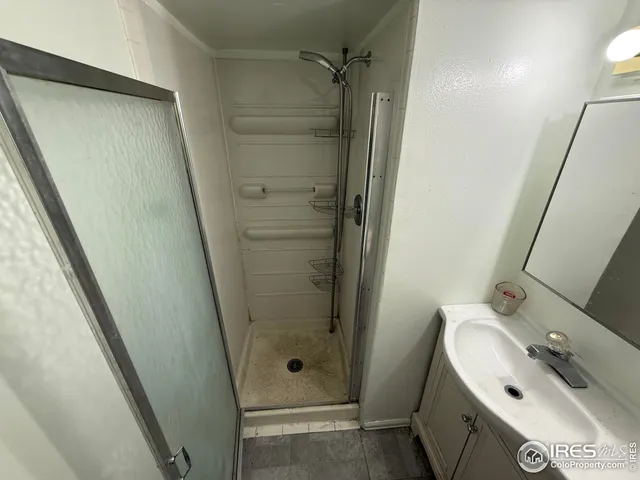 a white toilet sitting next to a bathroom sink and a mirror