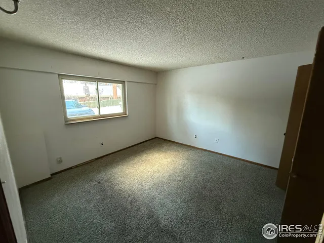 an empty room with closet area