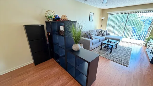 a living room with furniture and wooden floor