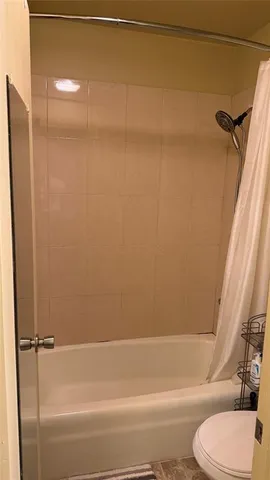 a bathroom with a shower and a toilet