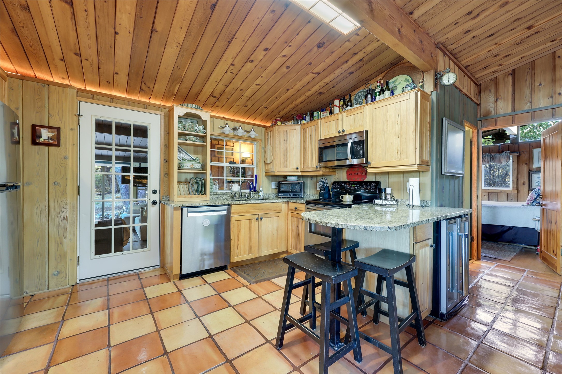 14606 Custer Court Austin, TX 78734 - Photo 10 of 35 Granite counters with Breakfast bar. Secondary Family room able to be enclosed with white door.