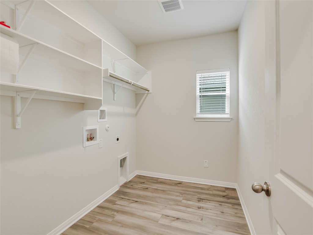 2818 Rustic Hills Drive Round Rock, TX 78665 - Photo 11 of 26 a view of a room with wooden floor and white walls