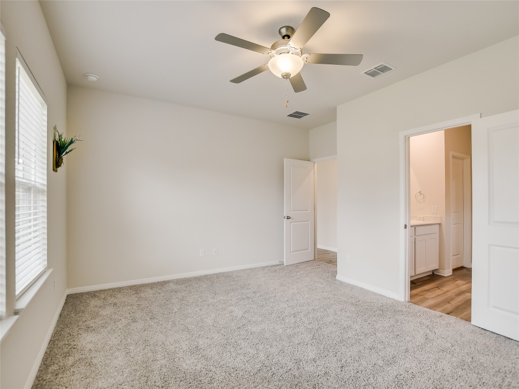 2818 Rustic Hills Drive Round Rock, TX 78665 - Photo 13 of 26 an empty room with a ceiling fan and a window
