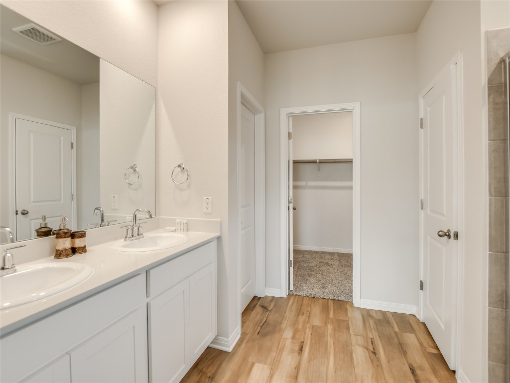 2818 Rustic Hills Drive Round Rock, TX 78665 - Photo 14 of 26 a bathroom with a sink and a mirror