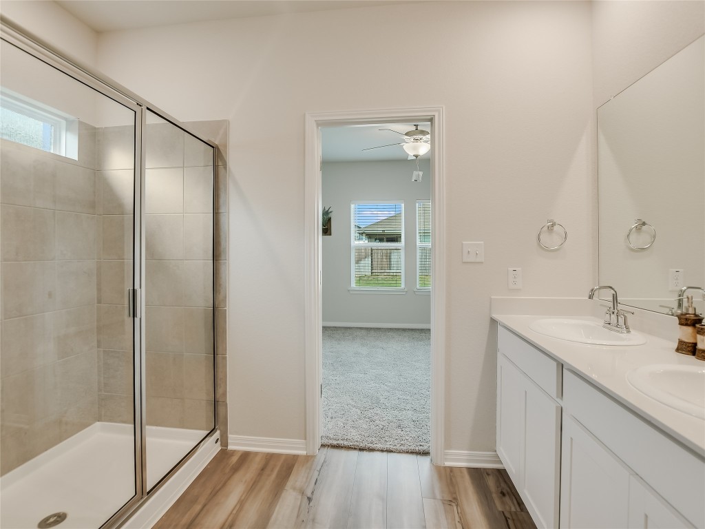 2818 Rustic Hills Drive Round Rock, TX 78665 - Photo 15 of 26 a bathroom with a sink and a mirror