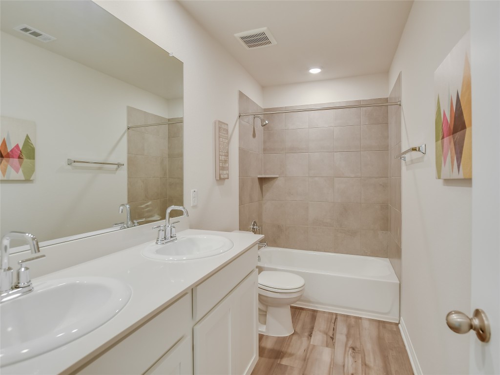 2818 Rustic Hills Drive Round Rock, TX 78665 - Photo 19 of 26 a bathroom with a sink a toilet and shower