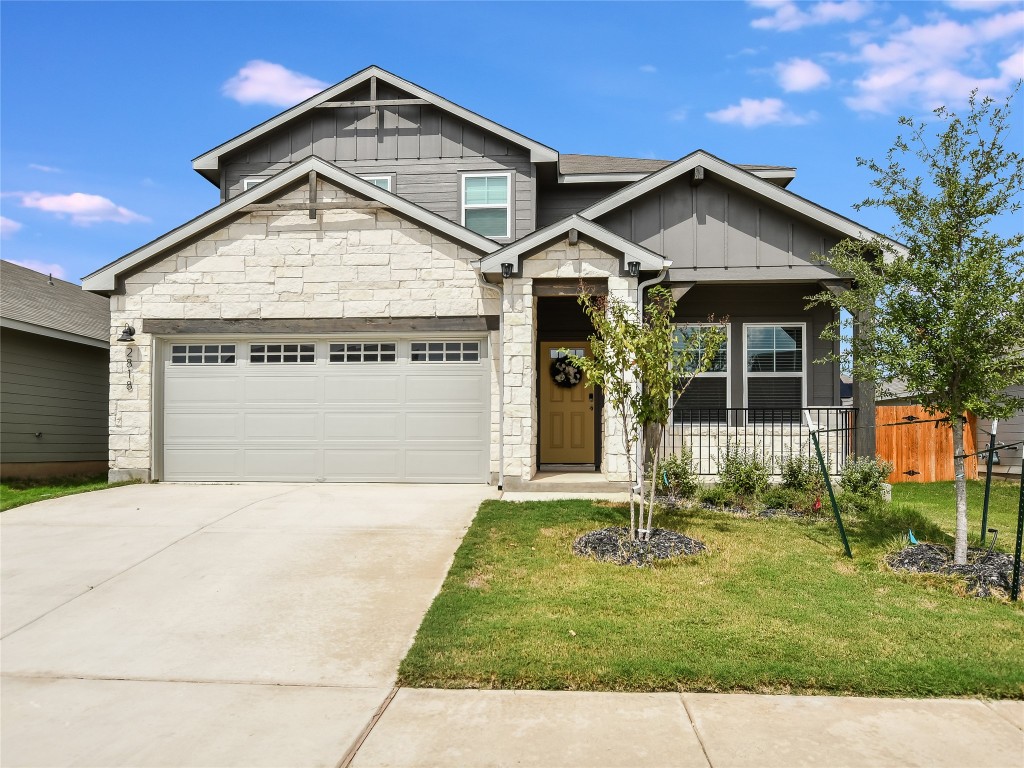 2818 Rustic Hills Drive Round Rock, TX 78665 - Photo 2 of 26 a front view of a house with a yard and garage