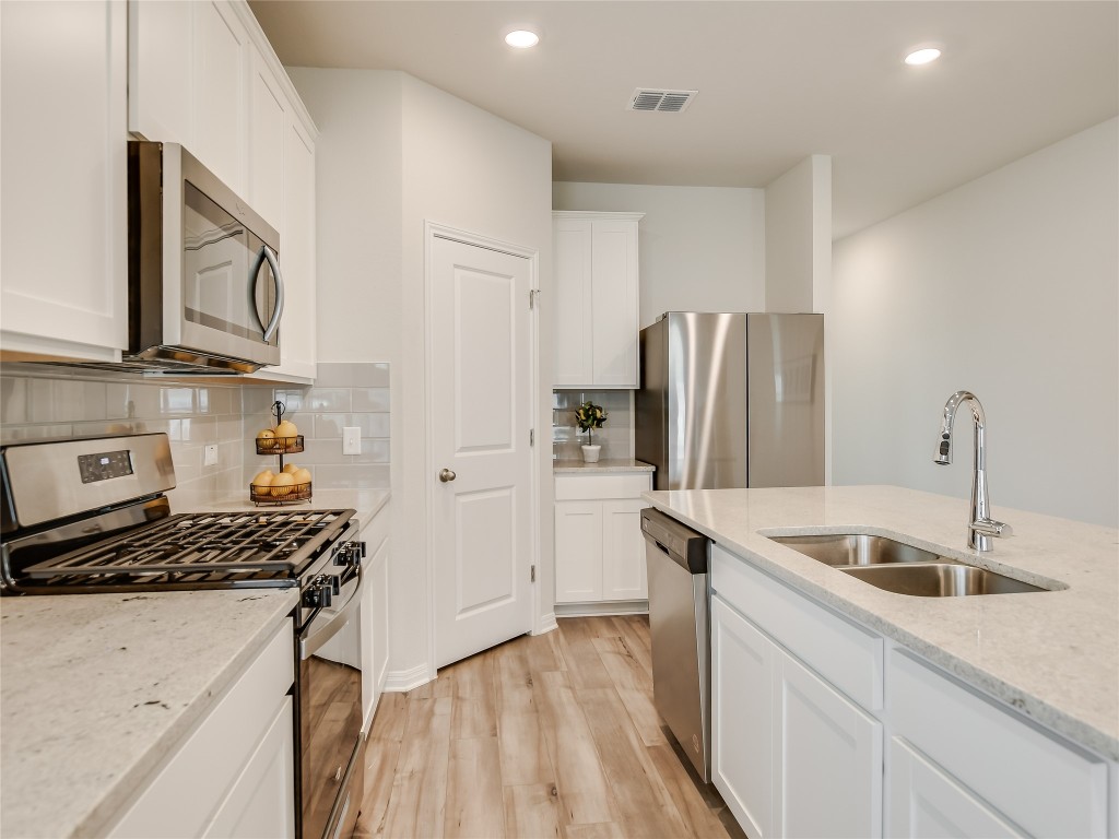 2818 Rustic Hills Drive Round Rock, TX 78665 - Photo 8 of 26 a kitchen that has a refrigerator and a sink