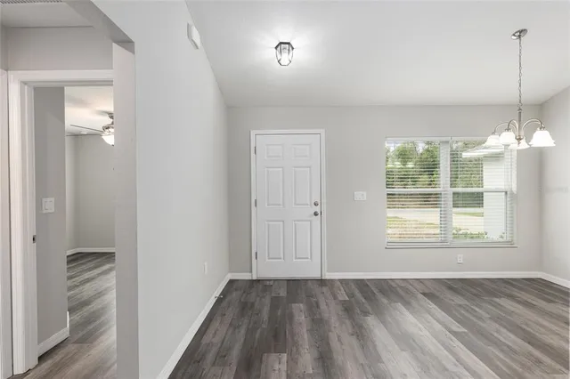 a kitchen with stainless steel appliances kitchen island granite countertop a refrigerator and a sink