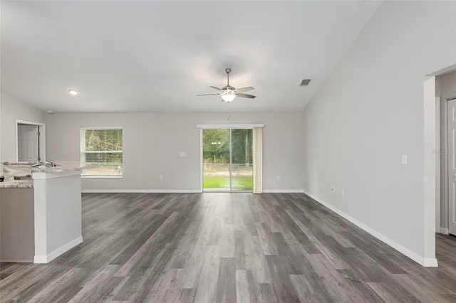 a kitchen with a granite countertop sink and window