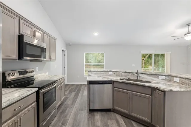 an empty room with a window and a ceiling fan