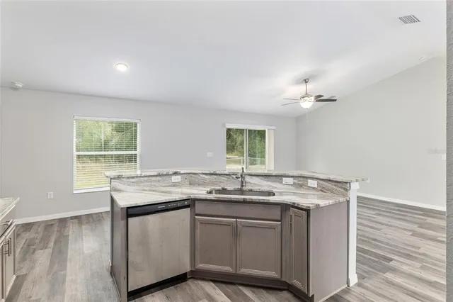 an empty room with wooden floor chandelier fan and closet area